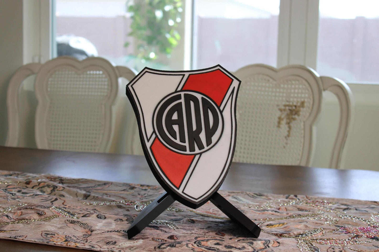 3D printed River Plate plaque on a table, showcasing vibrant colors and unique design for soccer fans and coaches.