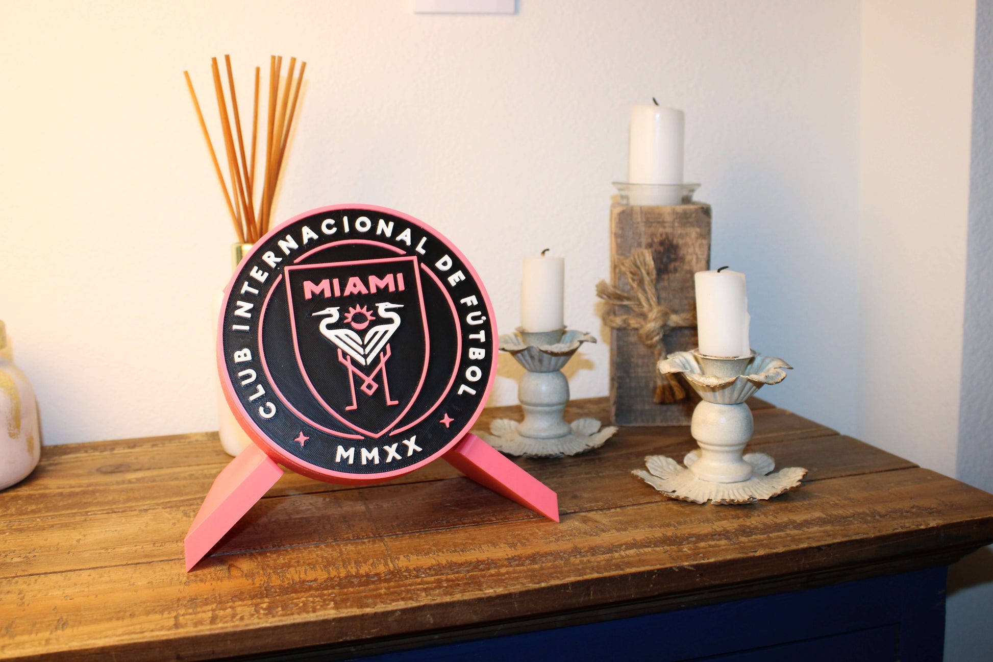 Inter Miami 3D printed emblem on a table, stylish decor for soccer fans, vibrant colors, high-quality materials.