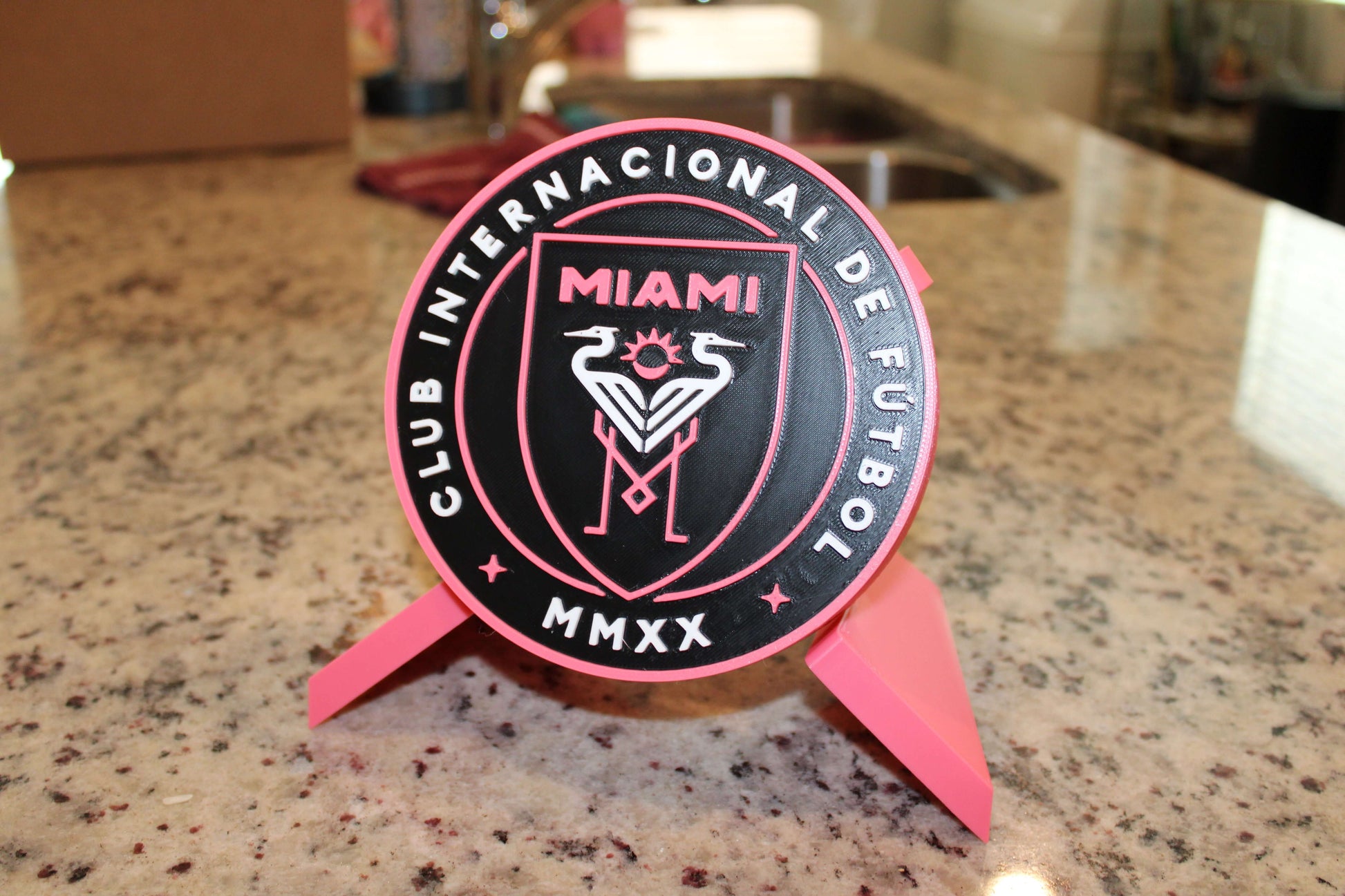 Stylish Inter Miami 3D Printed Emblem on a countertop, showcasing vibrant colors and high-quality design for soccer fans.
