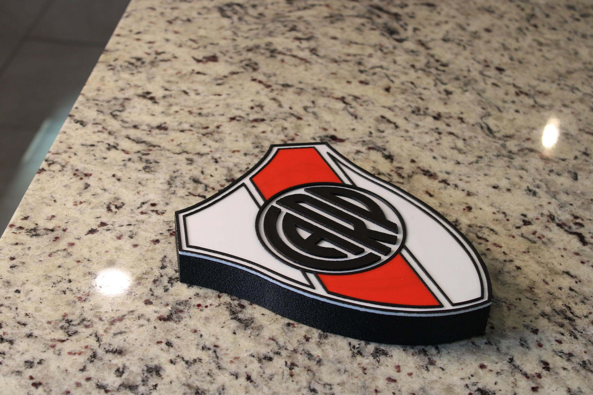 3D Printed River Plate plaque on granite surface, vibrant colors, no assembly required, unique soccer decor for fans.
