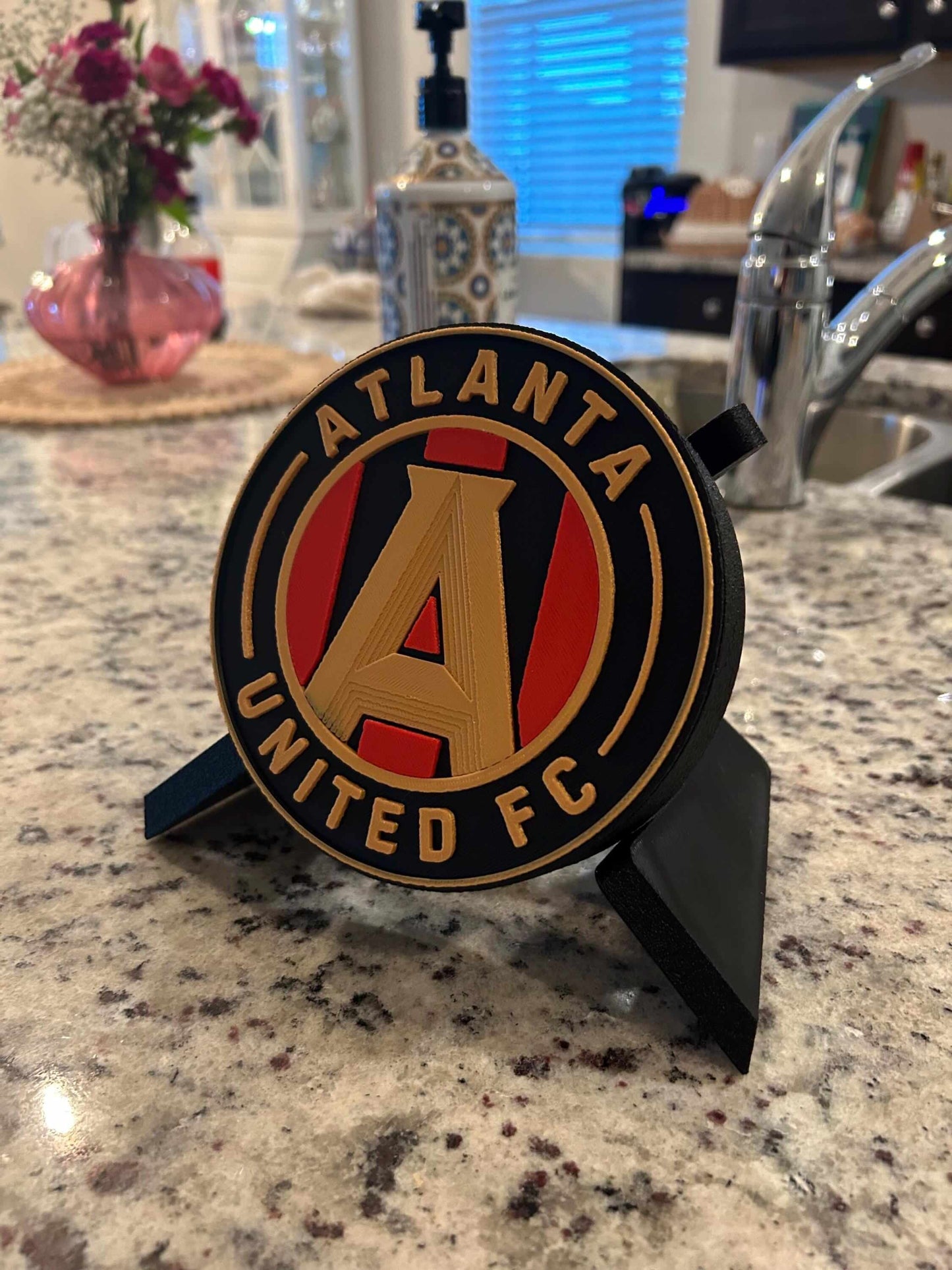 Atlanta United FC 3D printed plaque on kitchen counter, showcasing vibrant colors and unique design for soccer fans.