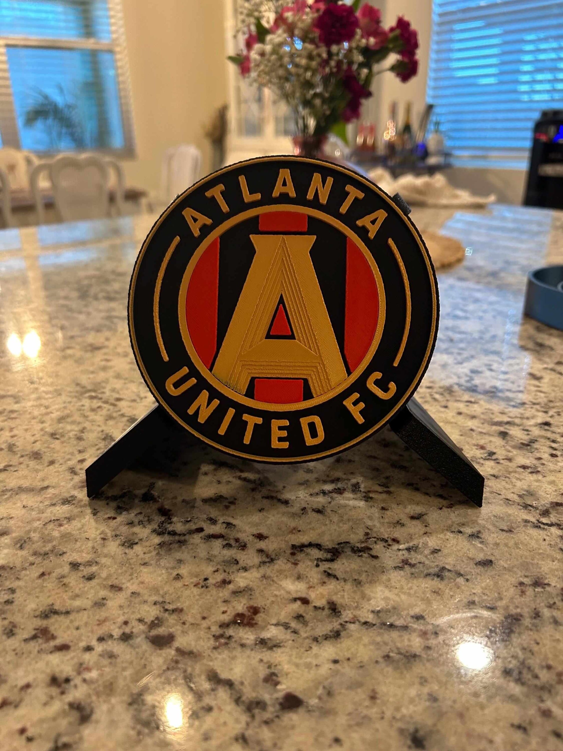 Atlanta United FC 3D printed plaque showcasing vibrant Five Stripes shield on a countertop.